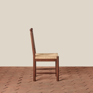 Wooden chair with a woven seat on a wooden floor and beige wall background - Number 4