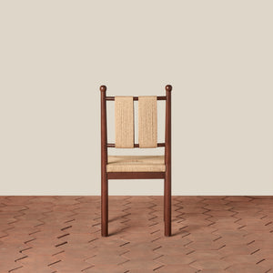 Wooden chair with woven backrest on a wooden floor and beige wall - Number 6