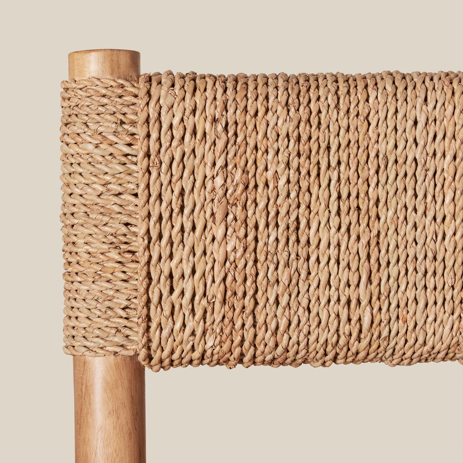 Close-up of a woven chair with wooden frame on a beige background- Number 7
