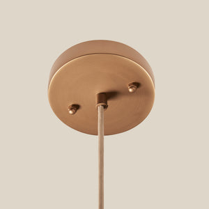 Brass pendant light fixture on a beige background - Number 11