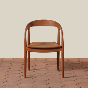 Wooden chair on a textured wooden floor with a neutral background - Number 5
