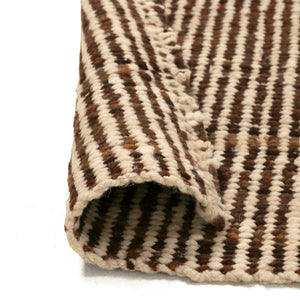 Close-up of a brown and beige striped rug corner on a white background - Number 3