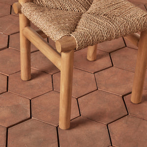 Wooden chair with woven seat on a hexagonal tile patio - Number 9