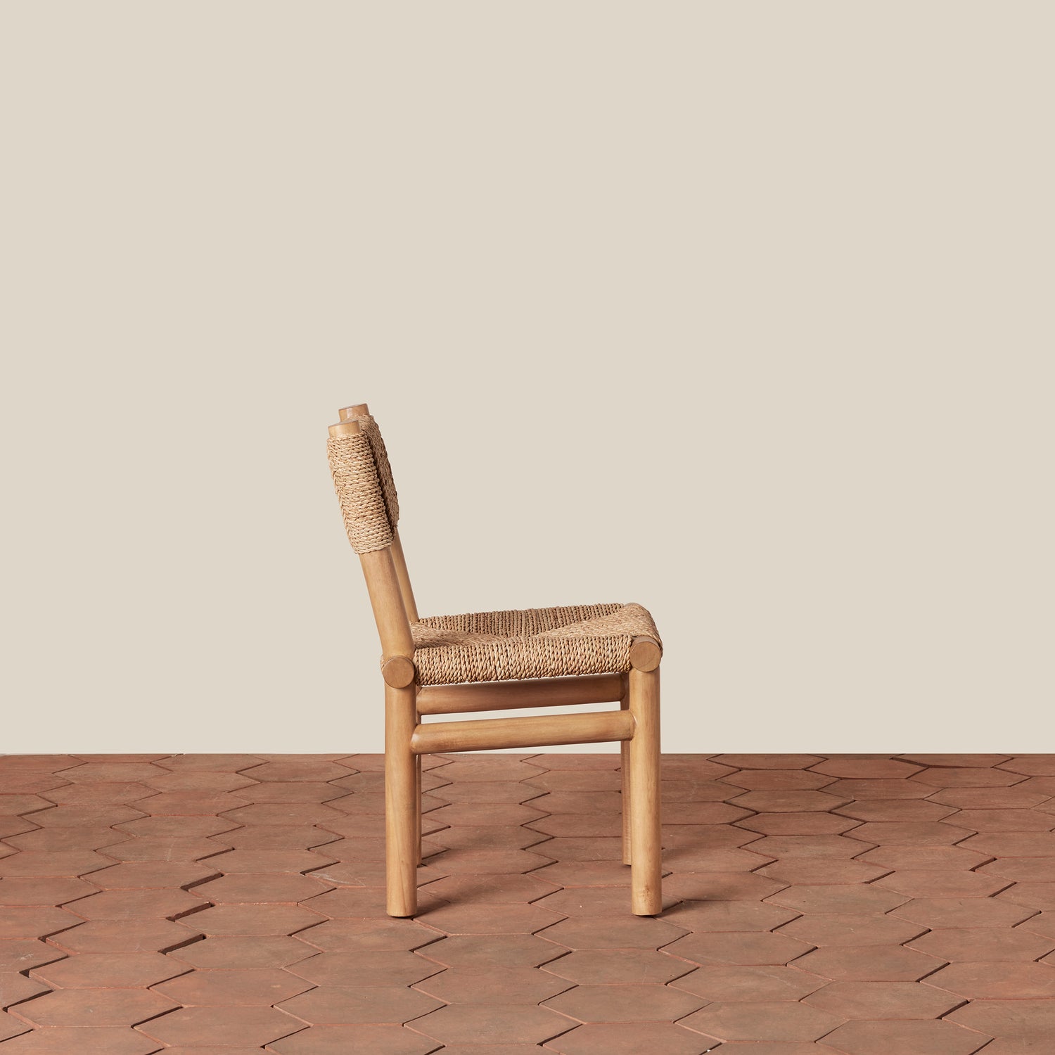Wooden chair with woven seat on a wooden floor and beige wall- Number 4