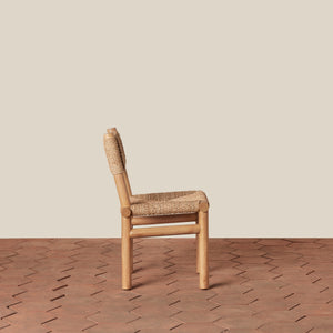 Wooden chair with woven seat on a wooden floor and beige wall - Number 5