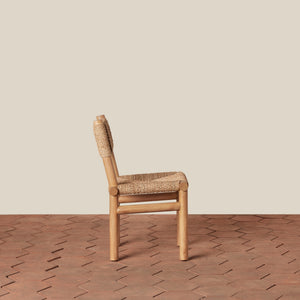 Wooden chair with woven seat on a wooden floor and beige wall - Number 4