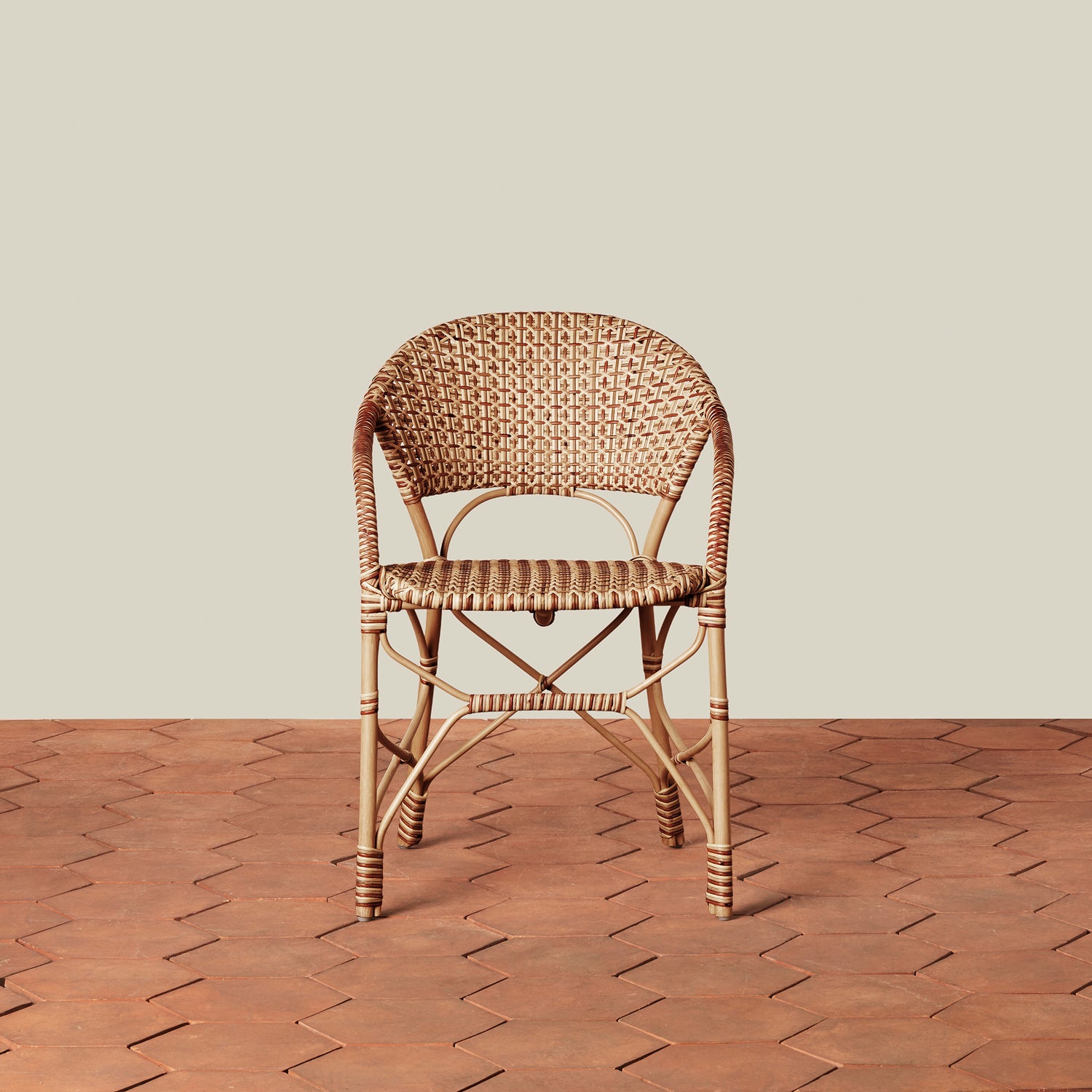 beige woven chair on tile floor with neutral background- Number 7