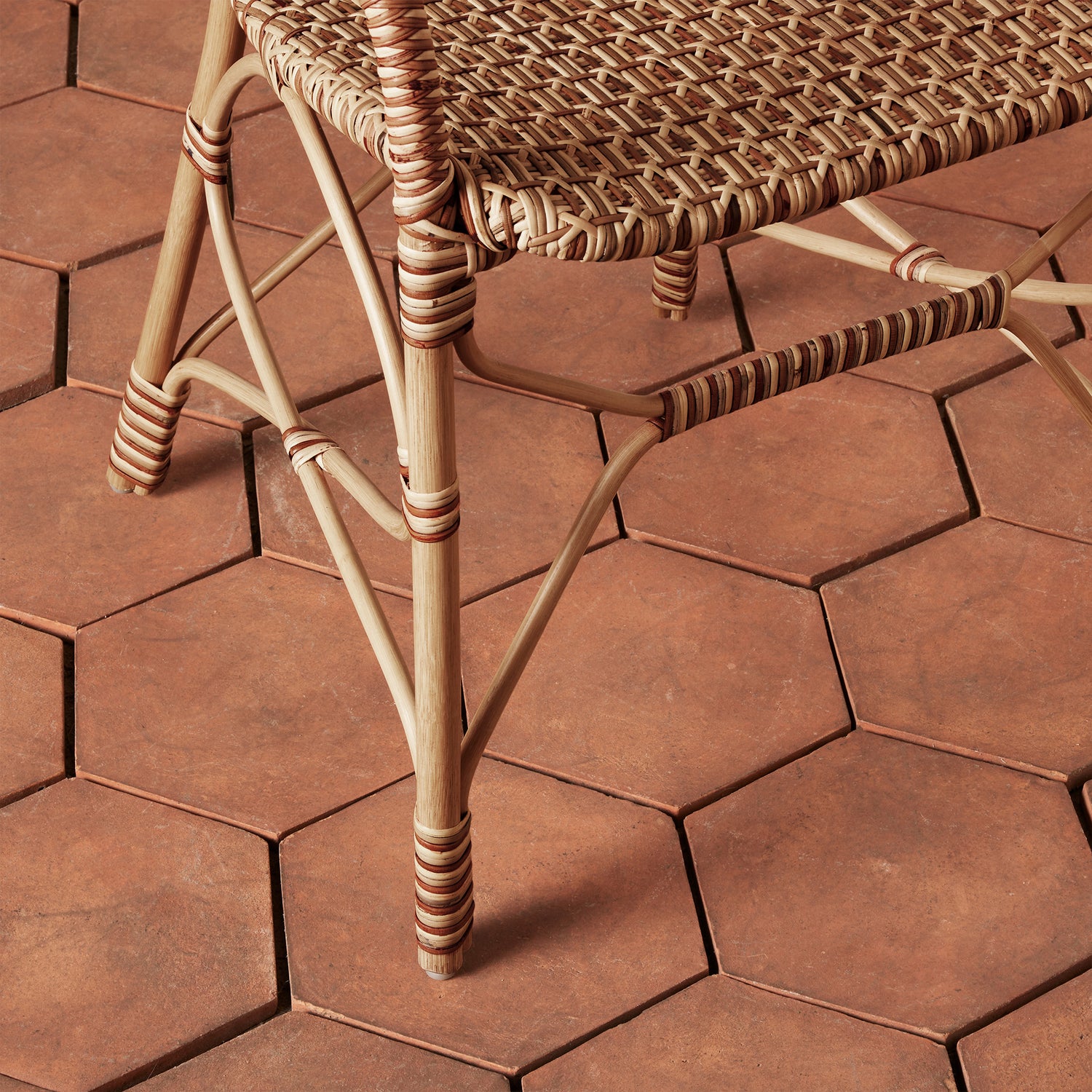 close up of woven chair legs on tile floor- Number 10