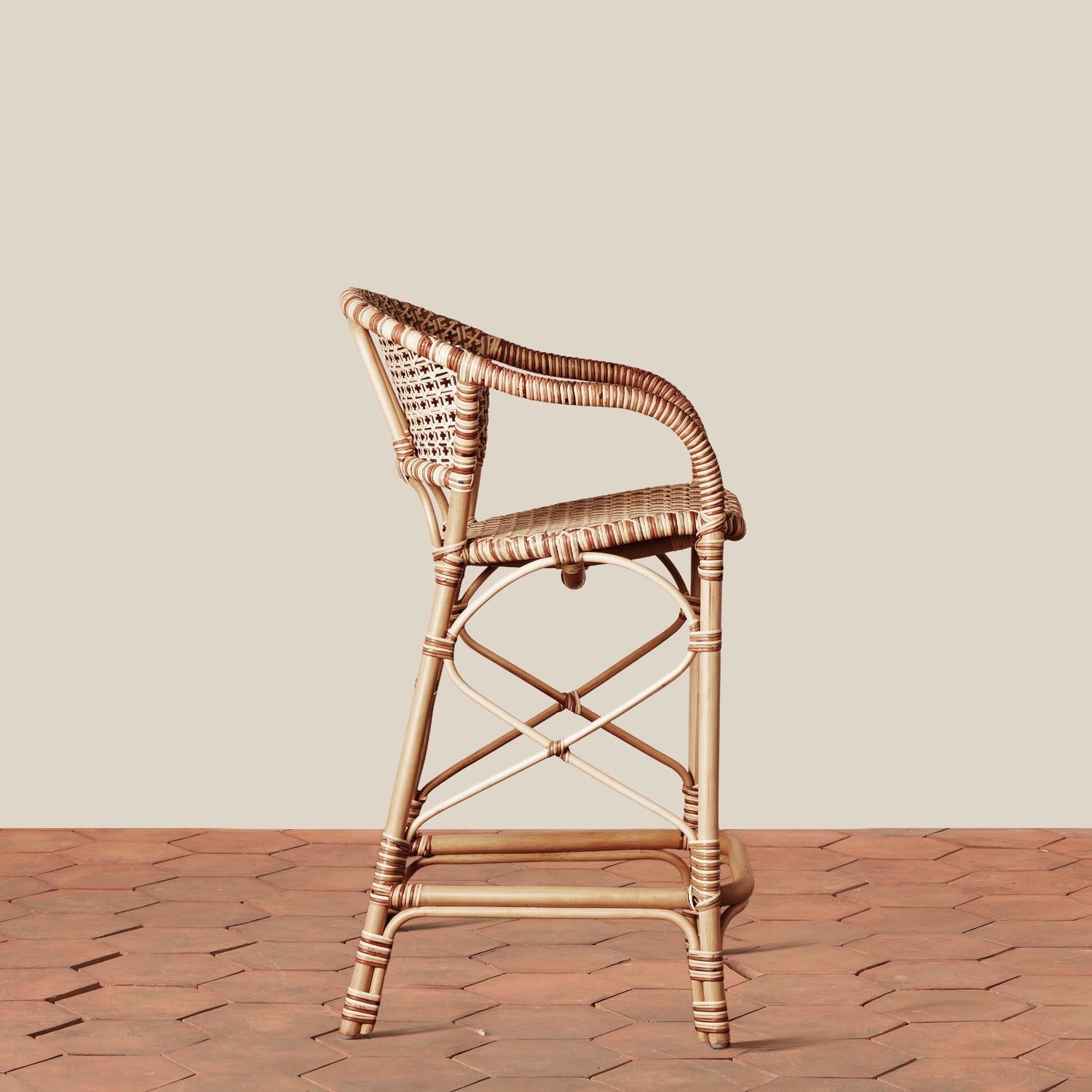 side of beige woven counter stool on tile floor with neutral background- Number 3