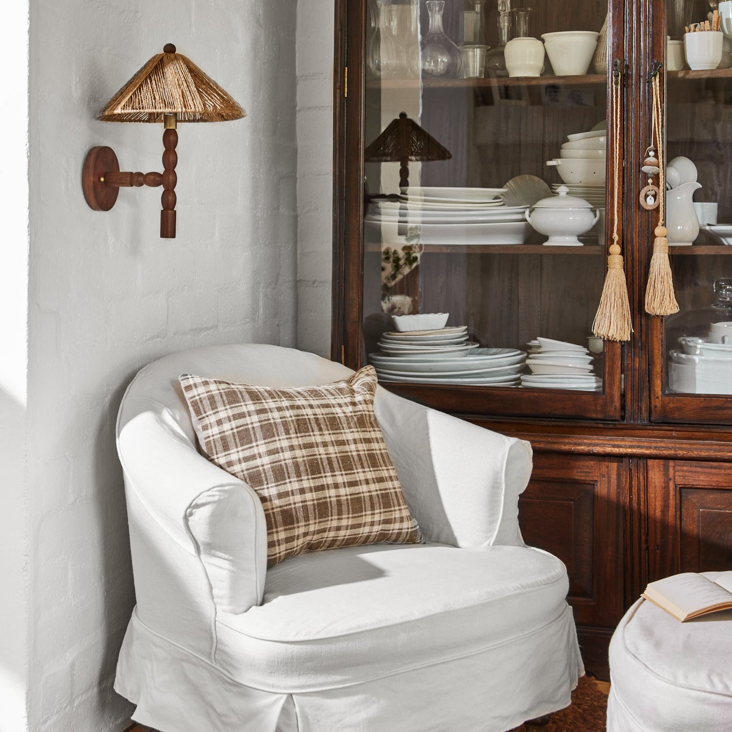 sconce hanging on white wall next to white lounge chair- Number 2