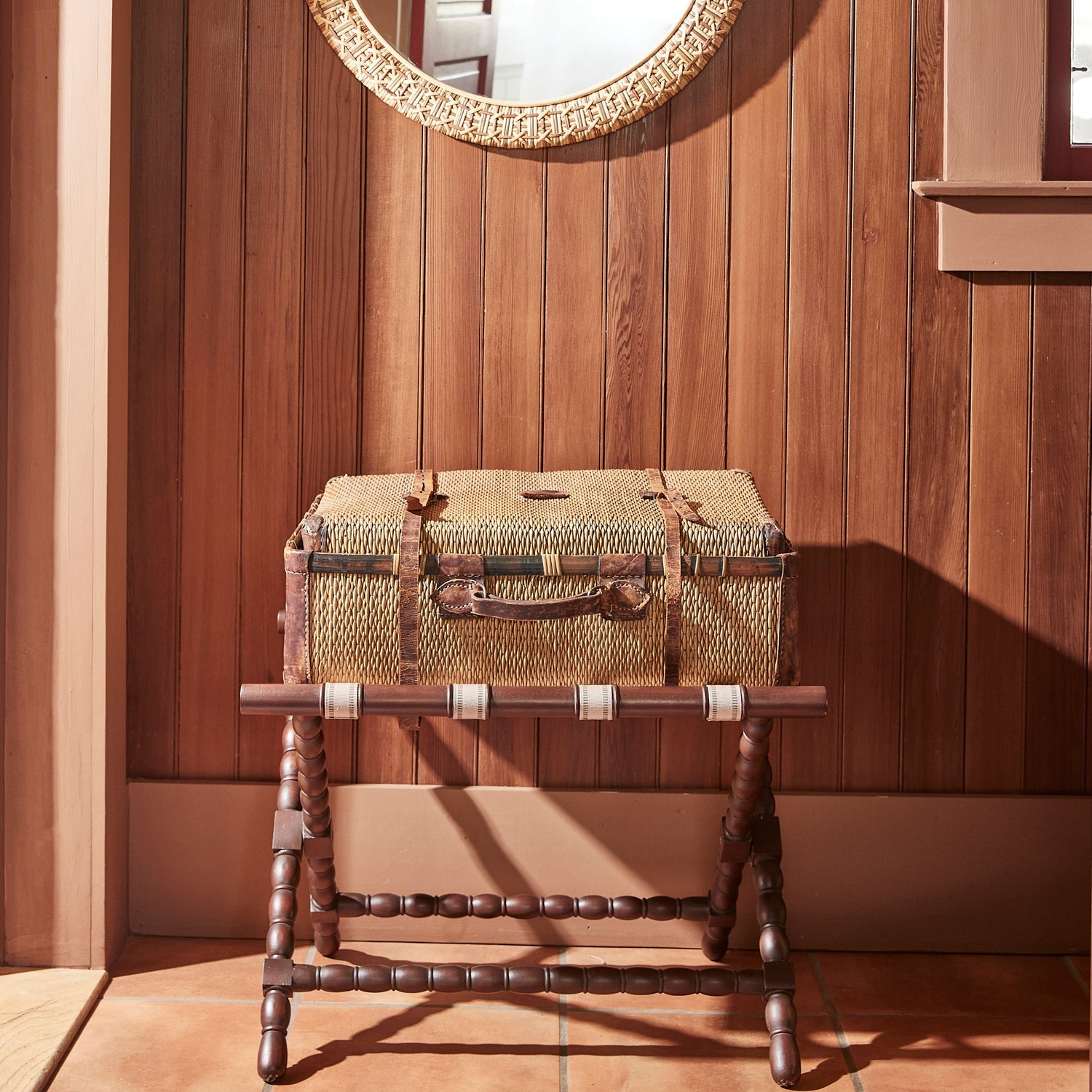 brown luggage rack with luggage on top, against wooden wall- Number 2