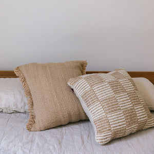 Two textured pillows on a bed with a neutral background - Number 4