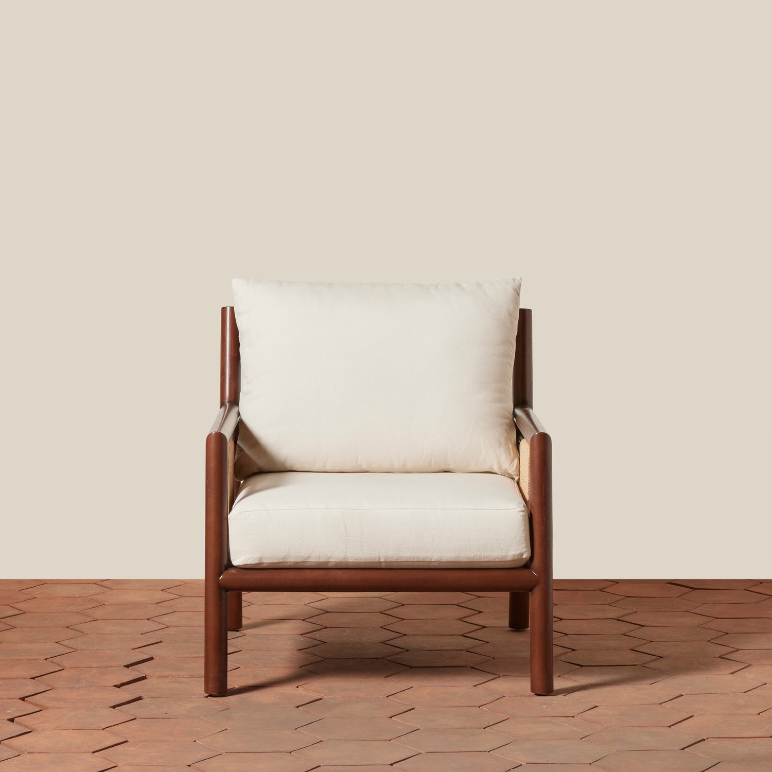 Wooden armchair with white cushions on a wooden floor and beige wall background- Number 3