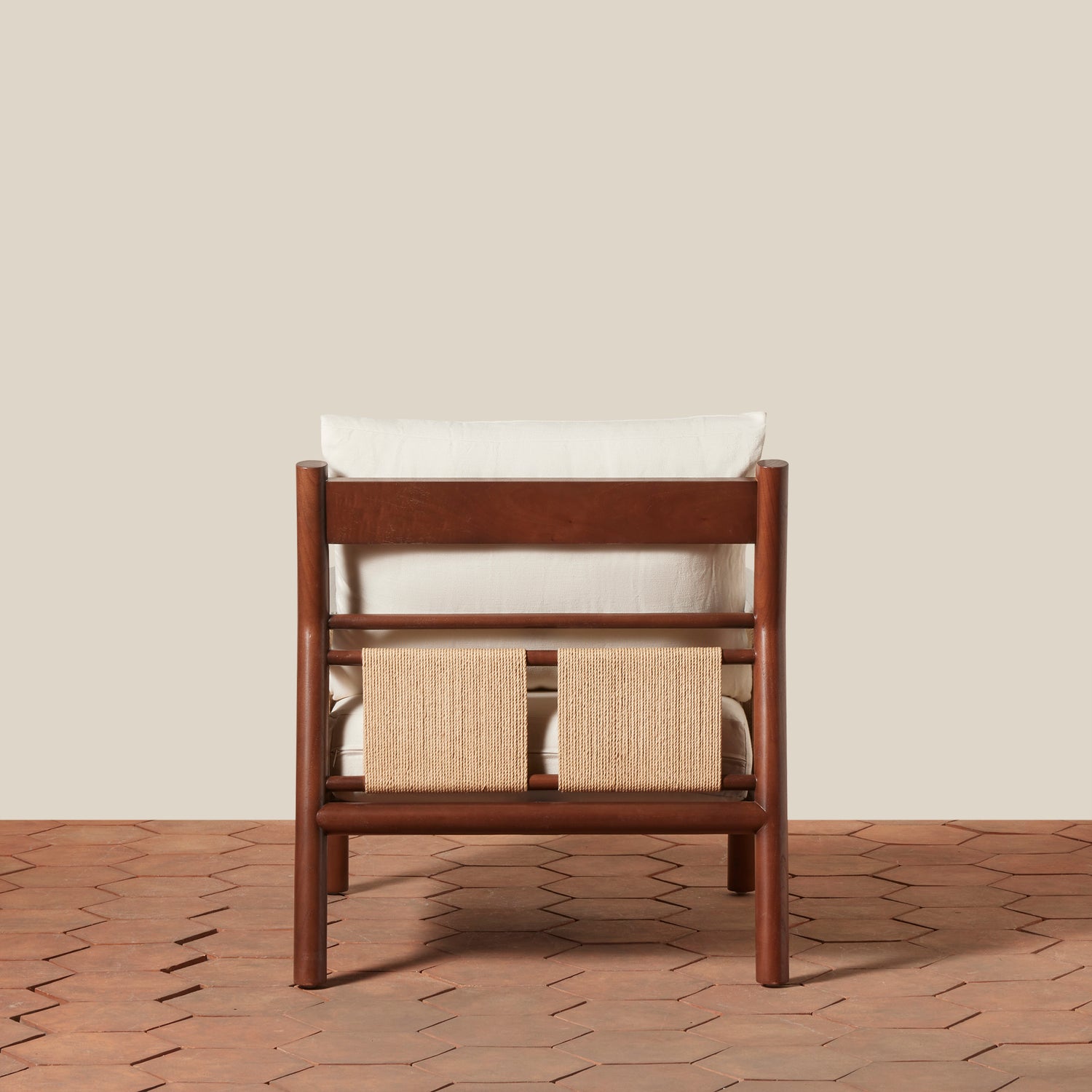 Wooden chair with white cushion and woven back on a beige background- Number 10