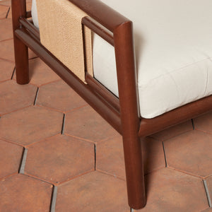 Brown wooden chair with white cushion on a terracotta tiled floor - Number 12