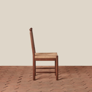 Wooden chair with a woven seat on a wooden floor and beige wall background - Number 4