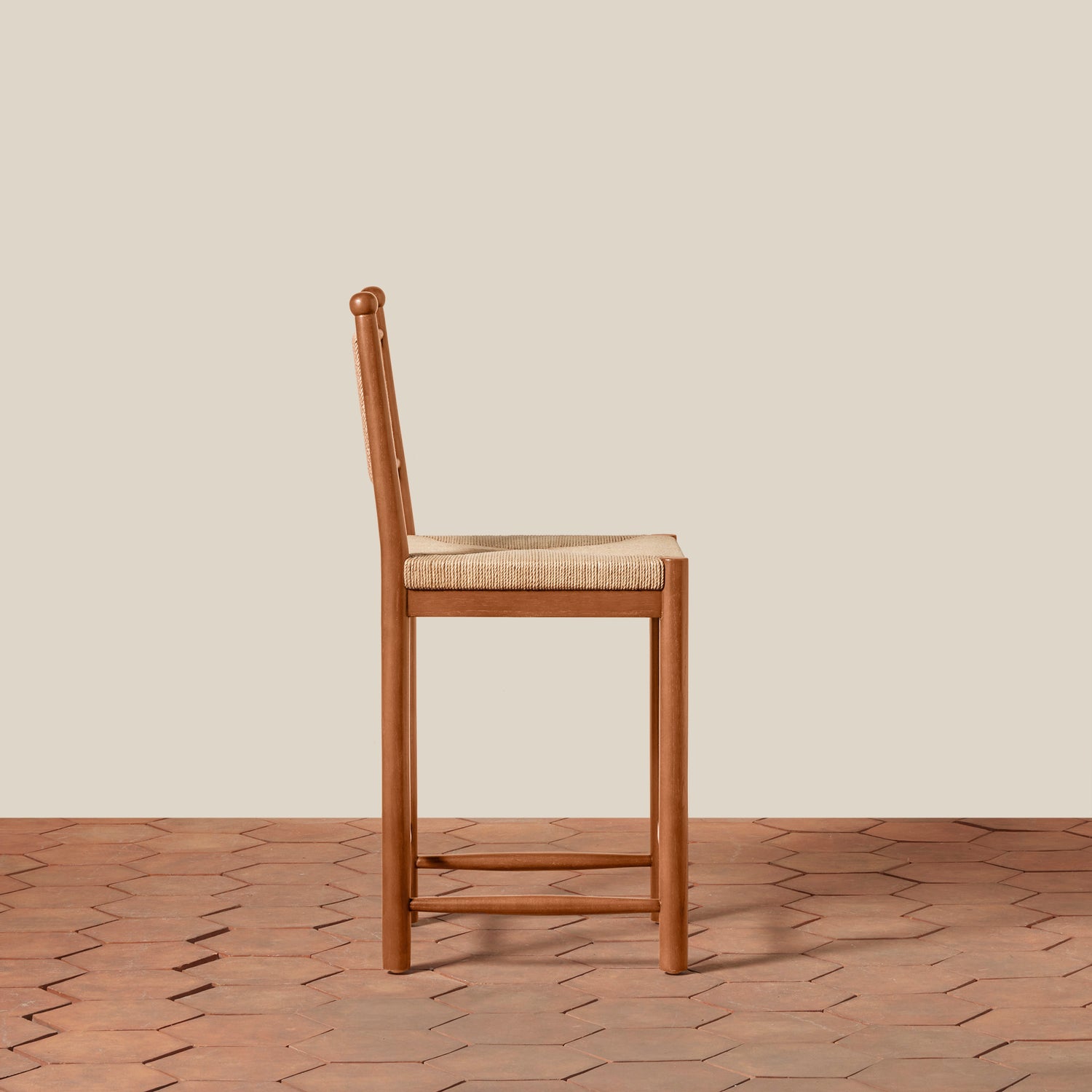 Wooden bar stool with woven seat on a wooden floor and beige wall background- Number 8
