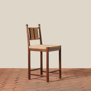 Wooden bar stool with woven backrest and seat on a wooden floor. - Number 1