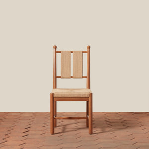 Wooden chair with woven backrest on a wooden floor and beige wall - Number 11