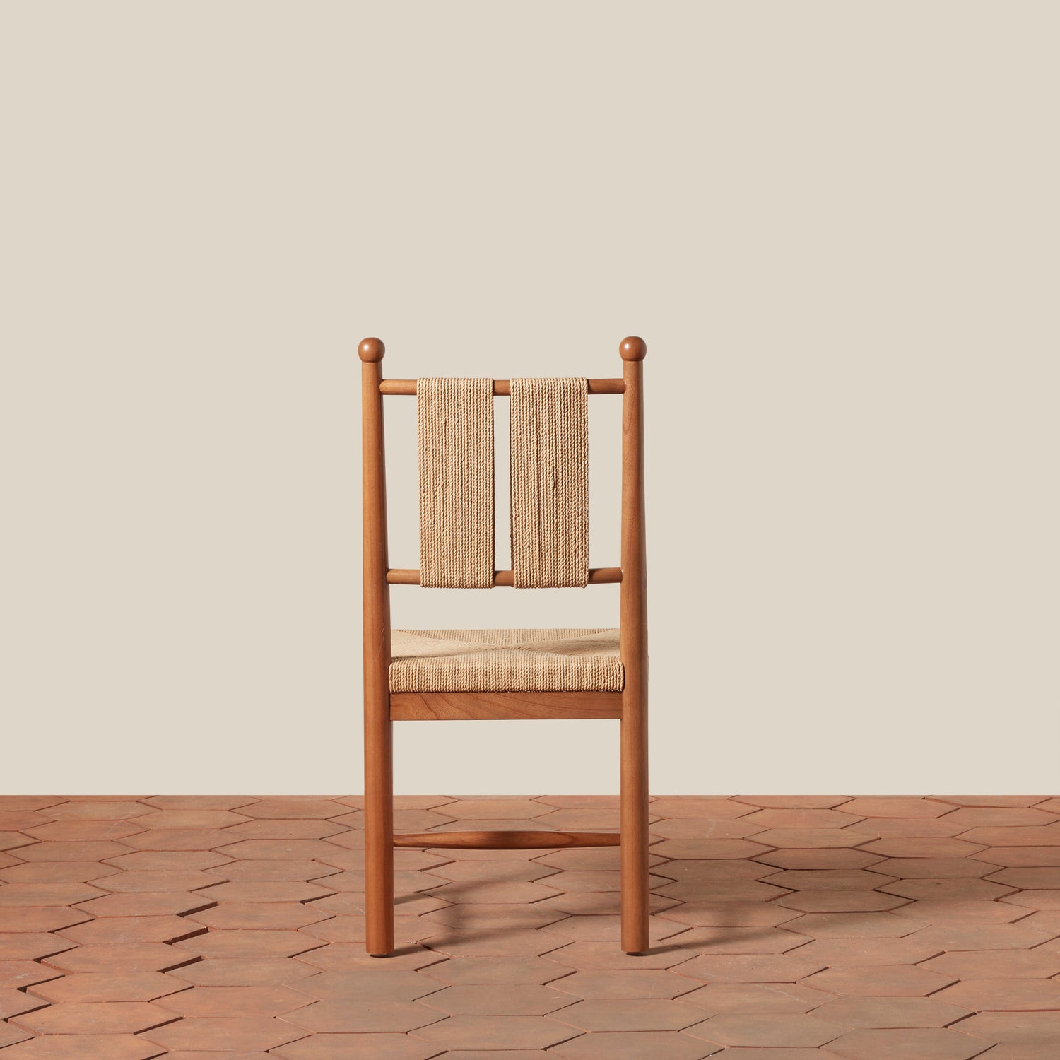 Wooden chair with woven backrest on a wooden floor and beige wall- Number 12