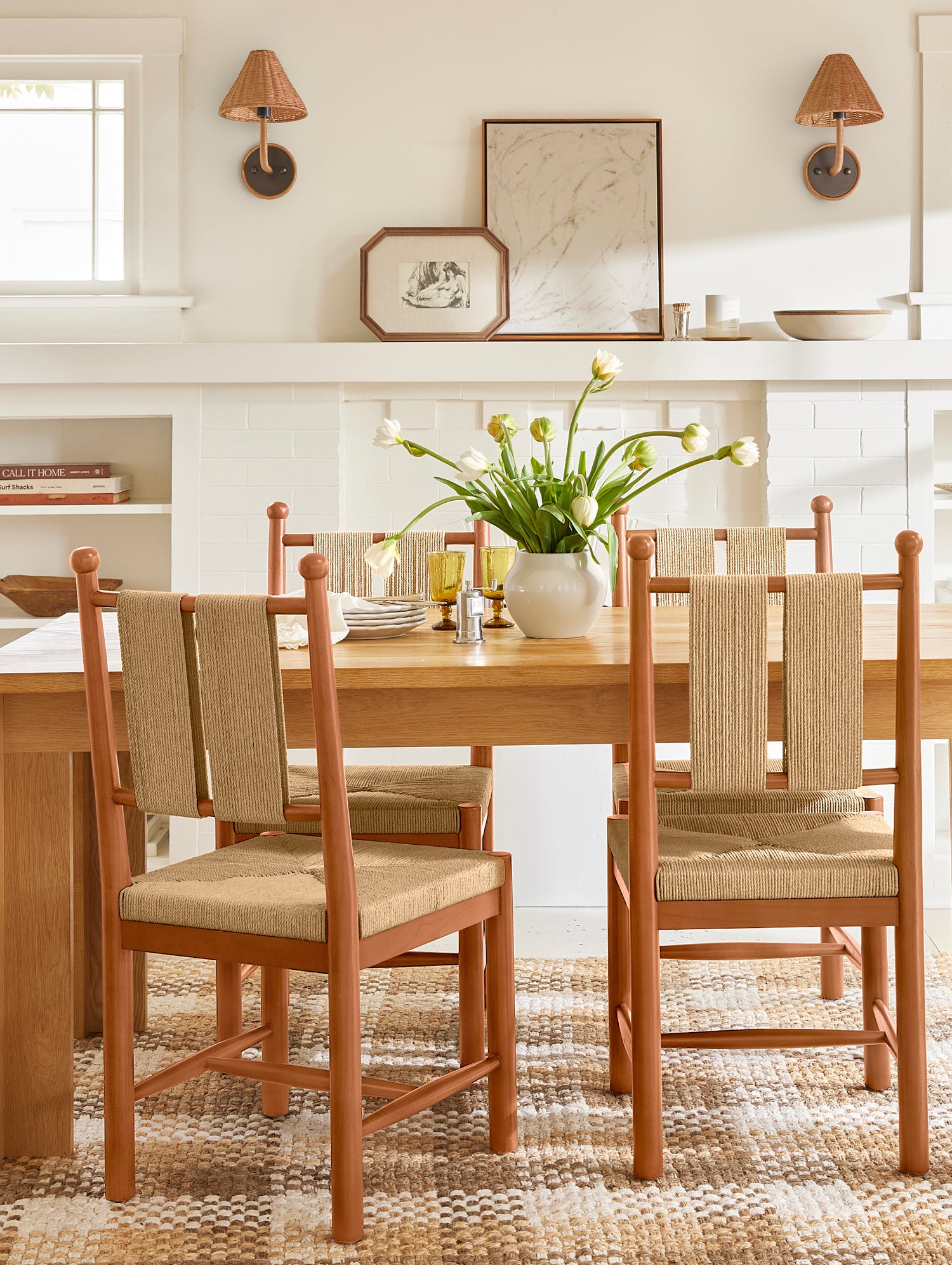 Dining room with wooden table and chairs, white walls, and decorative elements.- Number 10