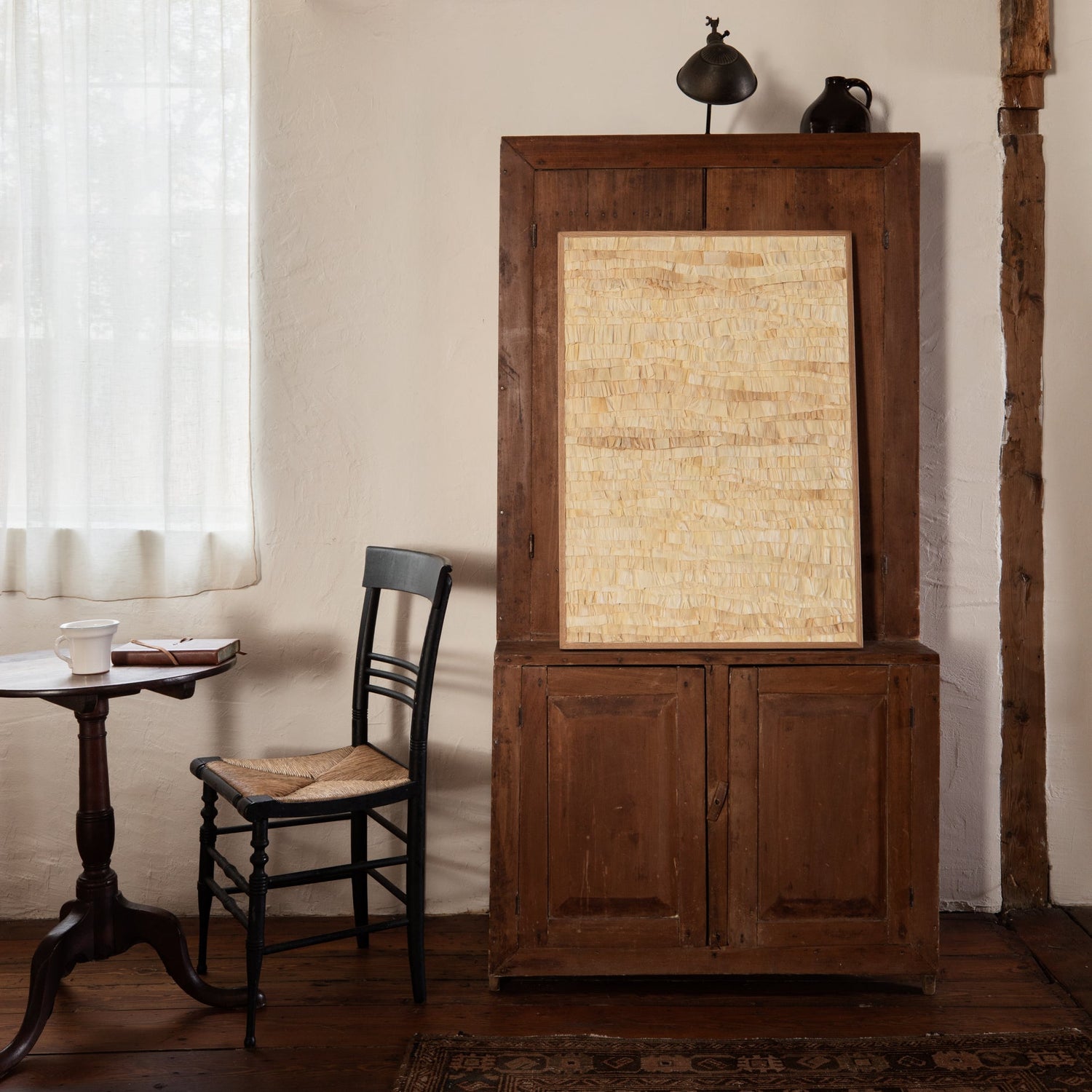Wooden cabinet with a mirror in a room with a table and chair.- Number 7