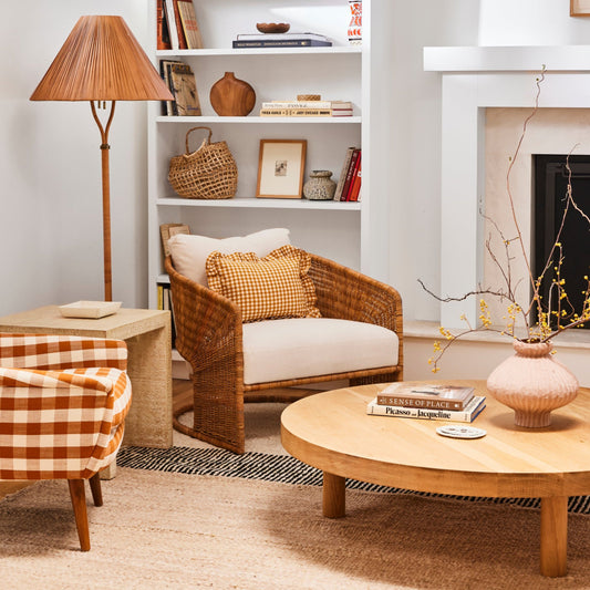 rattan lounge chair in living room next to lamp and round coffee table - Image 2