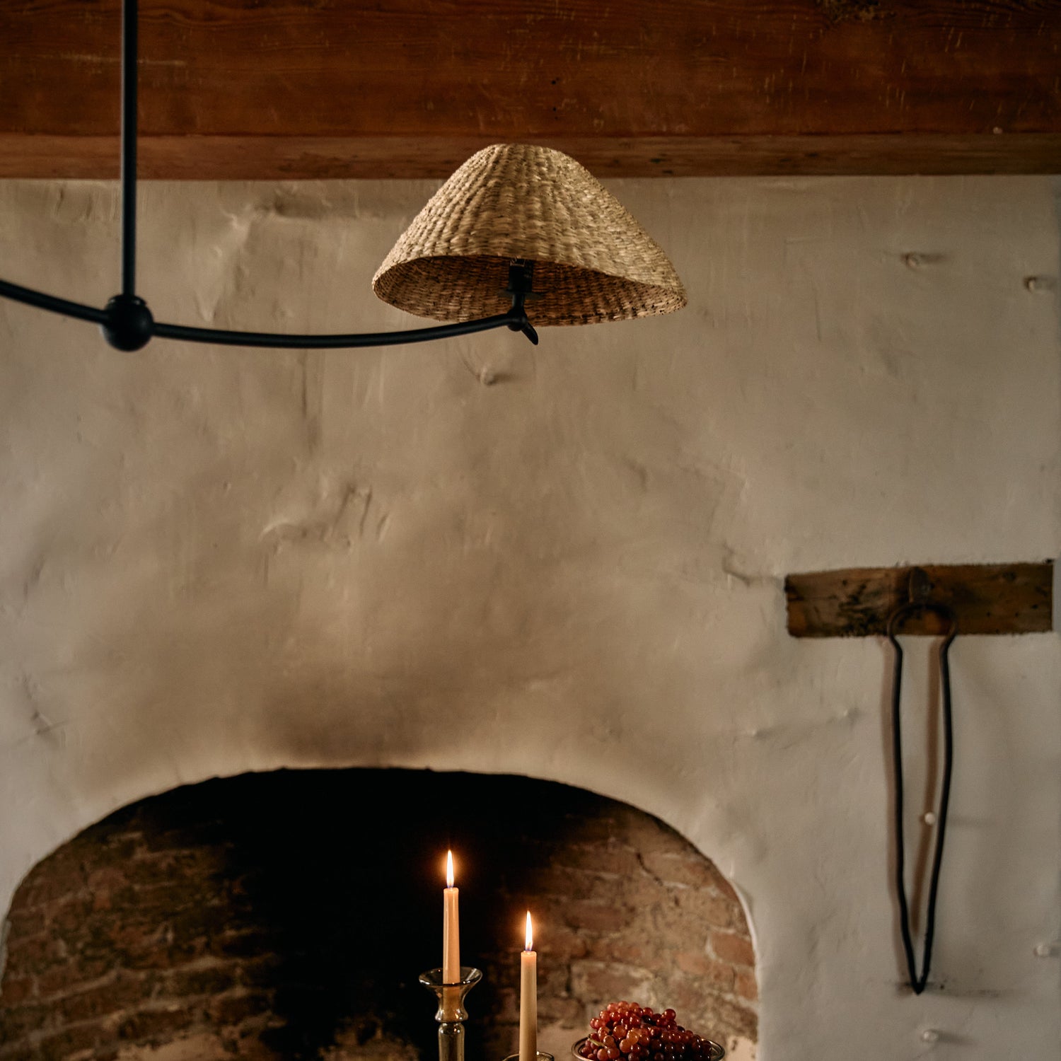 Dining table with candles and fruit in front of a stone fireplace.- Number 4