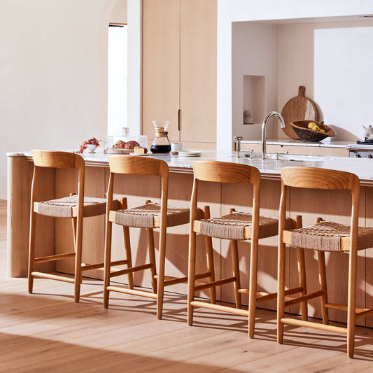 brown counter stools and kitchen island with white walls and brown cabinet - Image 2