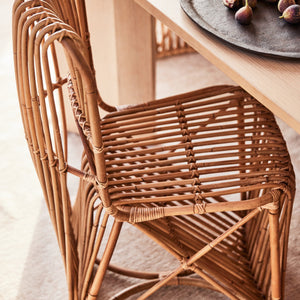 Wicker chair in a room with a table and decorative items - Number 3