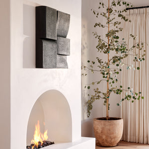 Modern living room with a white fireplace, decorative wall art, and a potted plant. - Number 2