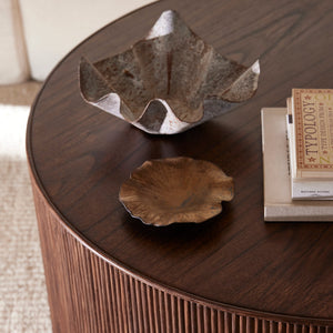 Round wooden coffee table with decorative items on a beige carpet - Number 3