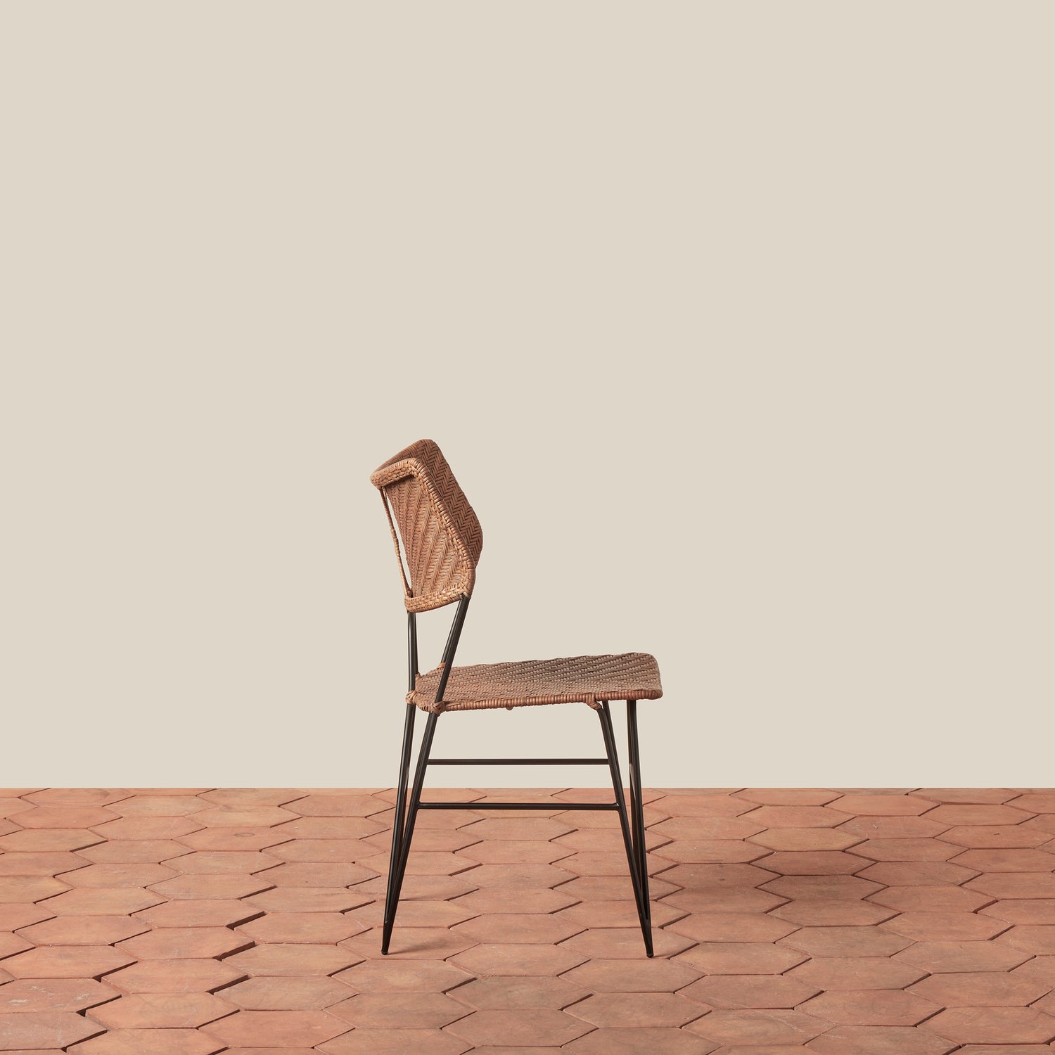 Wooden chair with woven backrest on a wooden floor and beige wall- Number 2