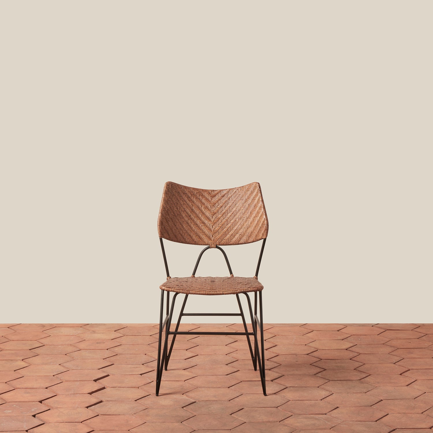 Woven chair with metal legs on a wooden floor and beige wall- Number 3