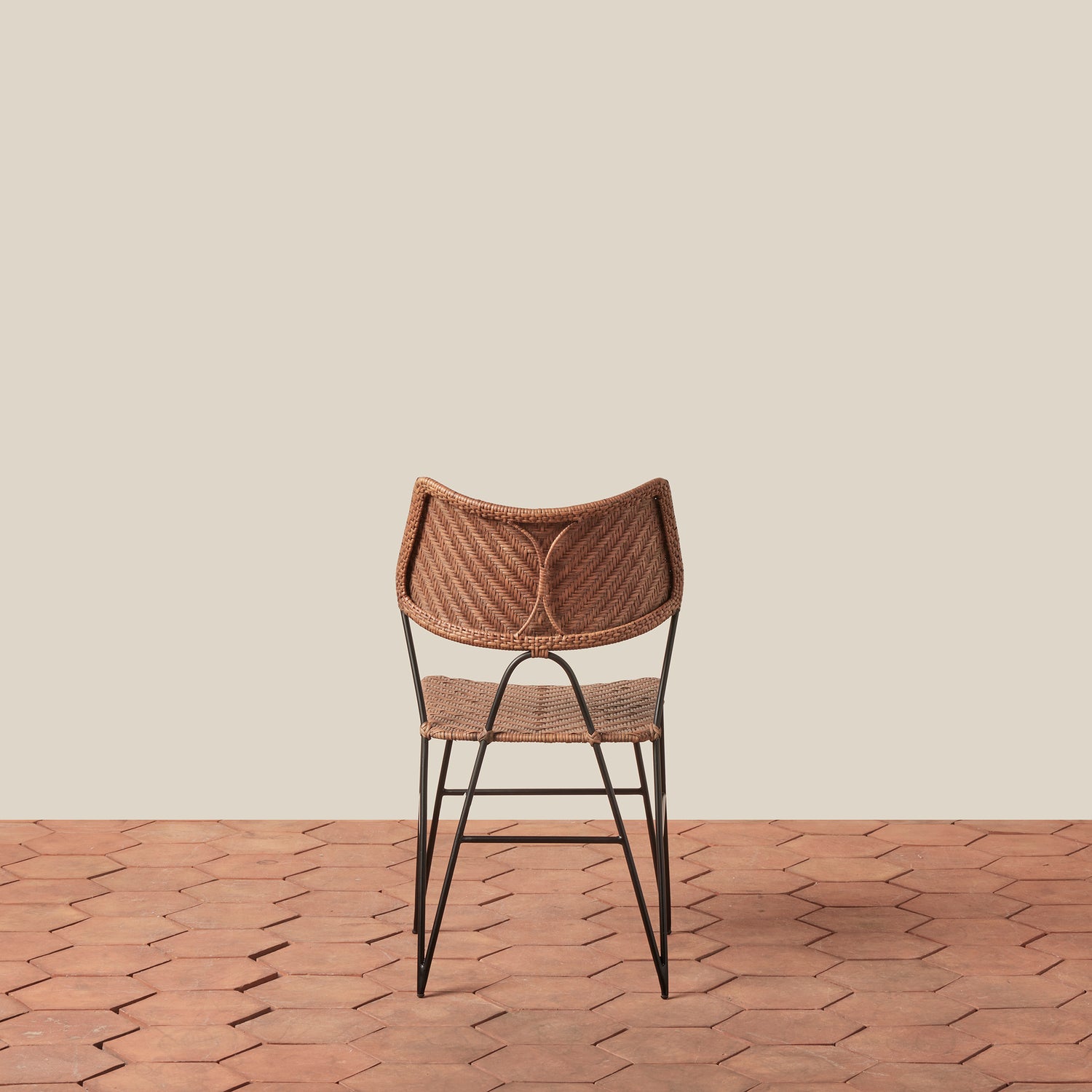 Woven chair with metal legs on a wooden floor and beige wall- Number 4