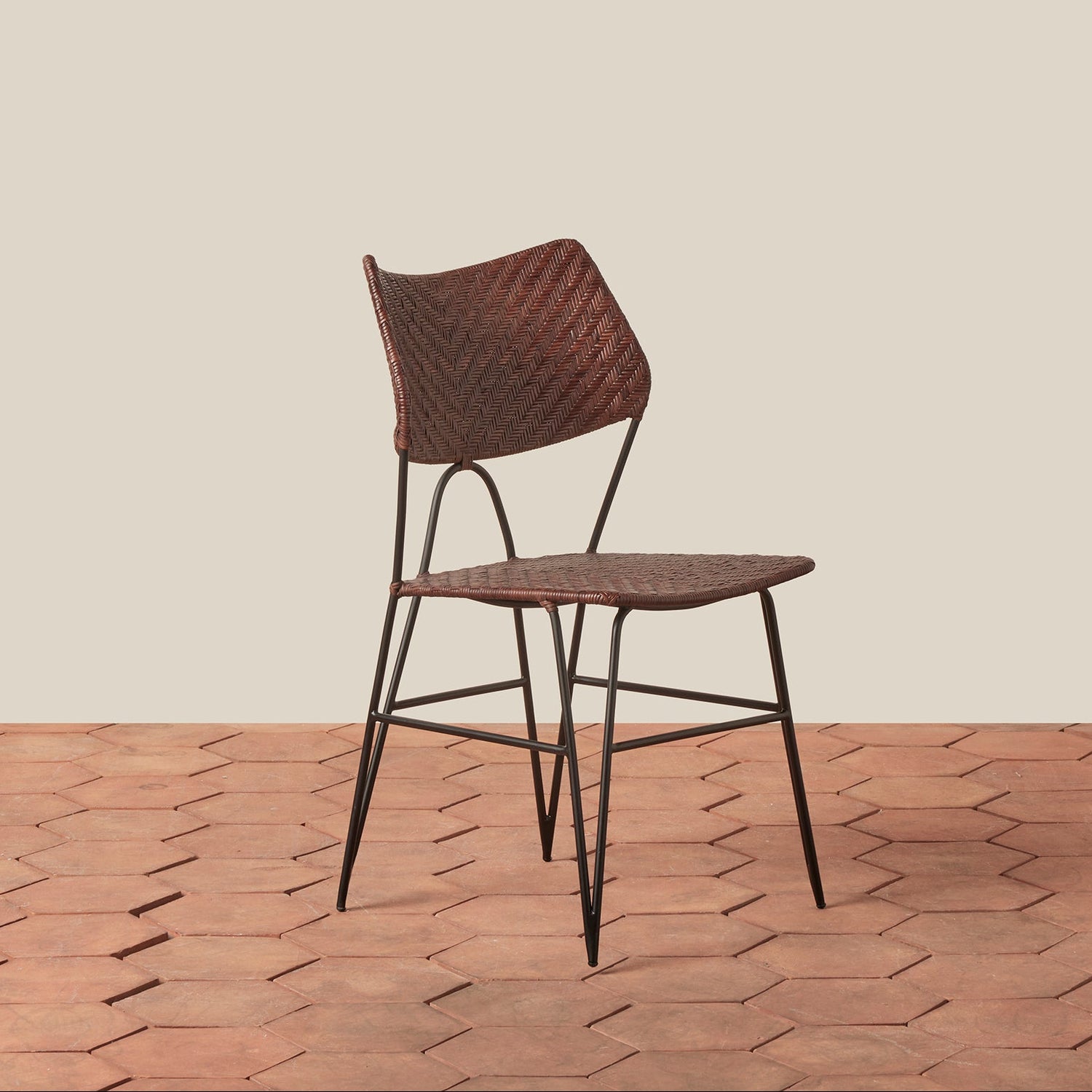 Woven chair on a wooden floor with a beige wall background- Number 7