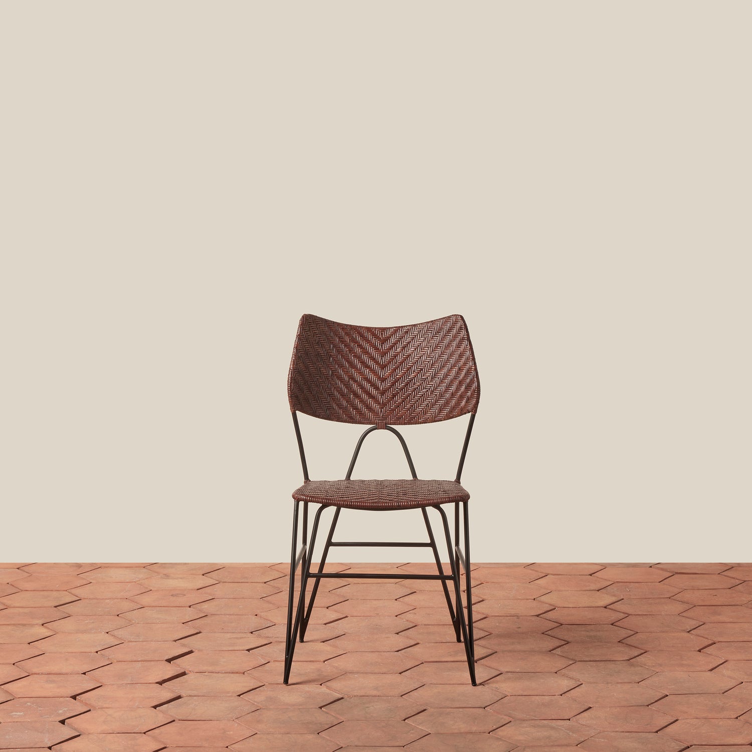 Brown chair with wicker backrest on a wooden floor and beige wall- Number 9