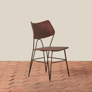 Woven chair on a wooden floor with a beige wall background - Number 7