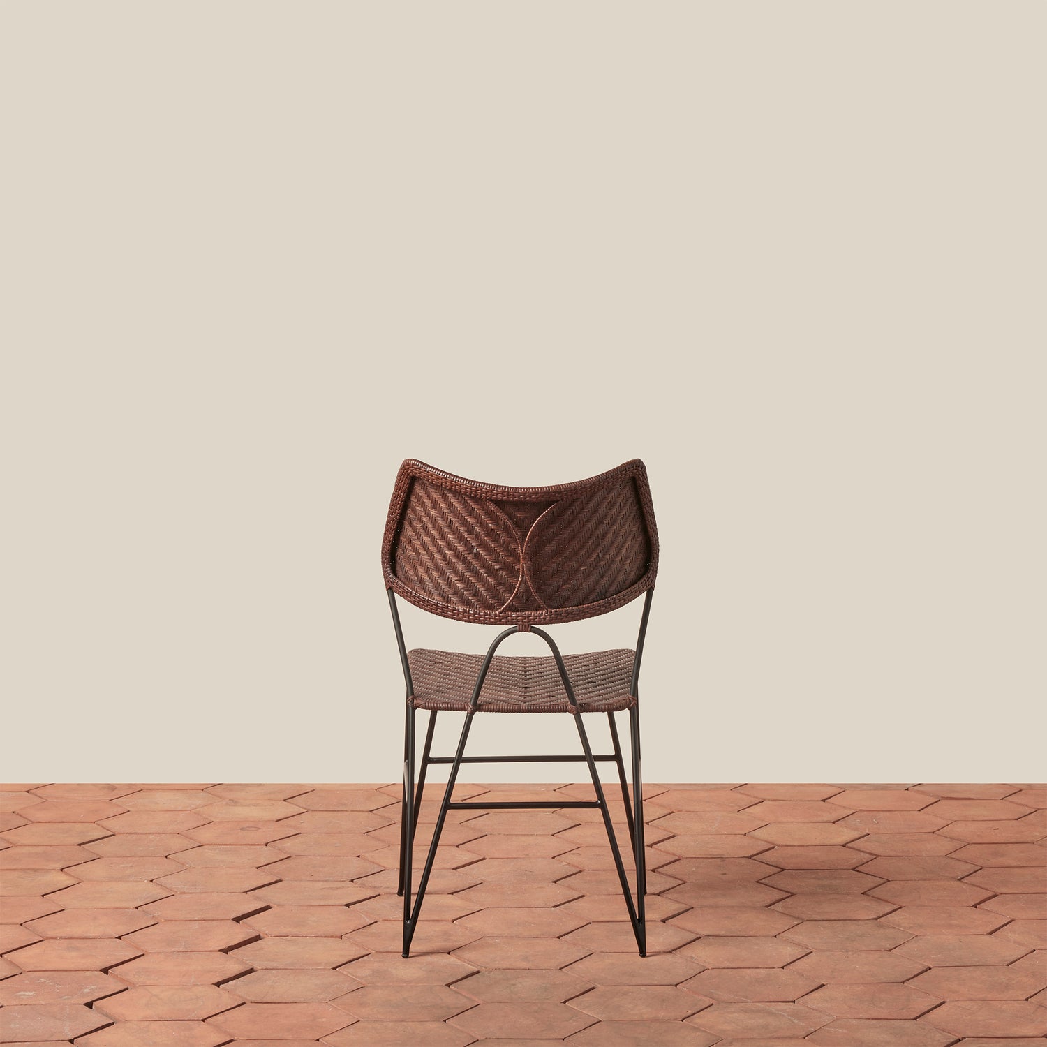Woven chair on a wooden floor with a beige wall background- Number 10