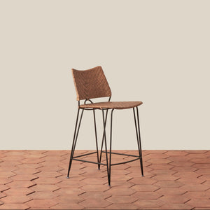 Bar stool with woven seat and backrest on a wooden floor. - Number 1
