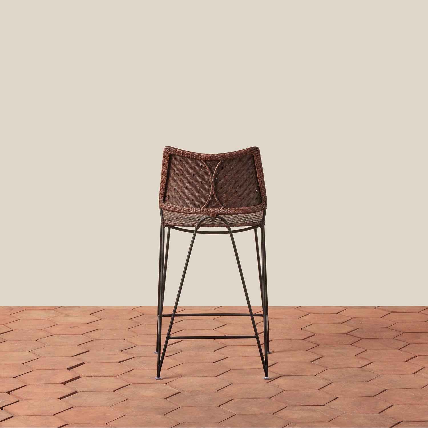 Bar stool with woven backrest on a wooden floor and beige wall- Number 10