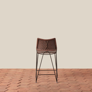 Bar stool with woven backrest on a wooden floor and beige wall - Number 10