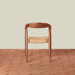Wooden chair with woven seat on a wooden floor and beige wall background - Number 4
