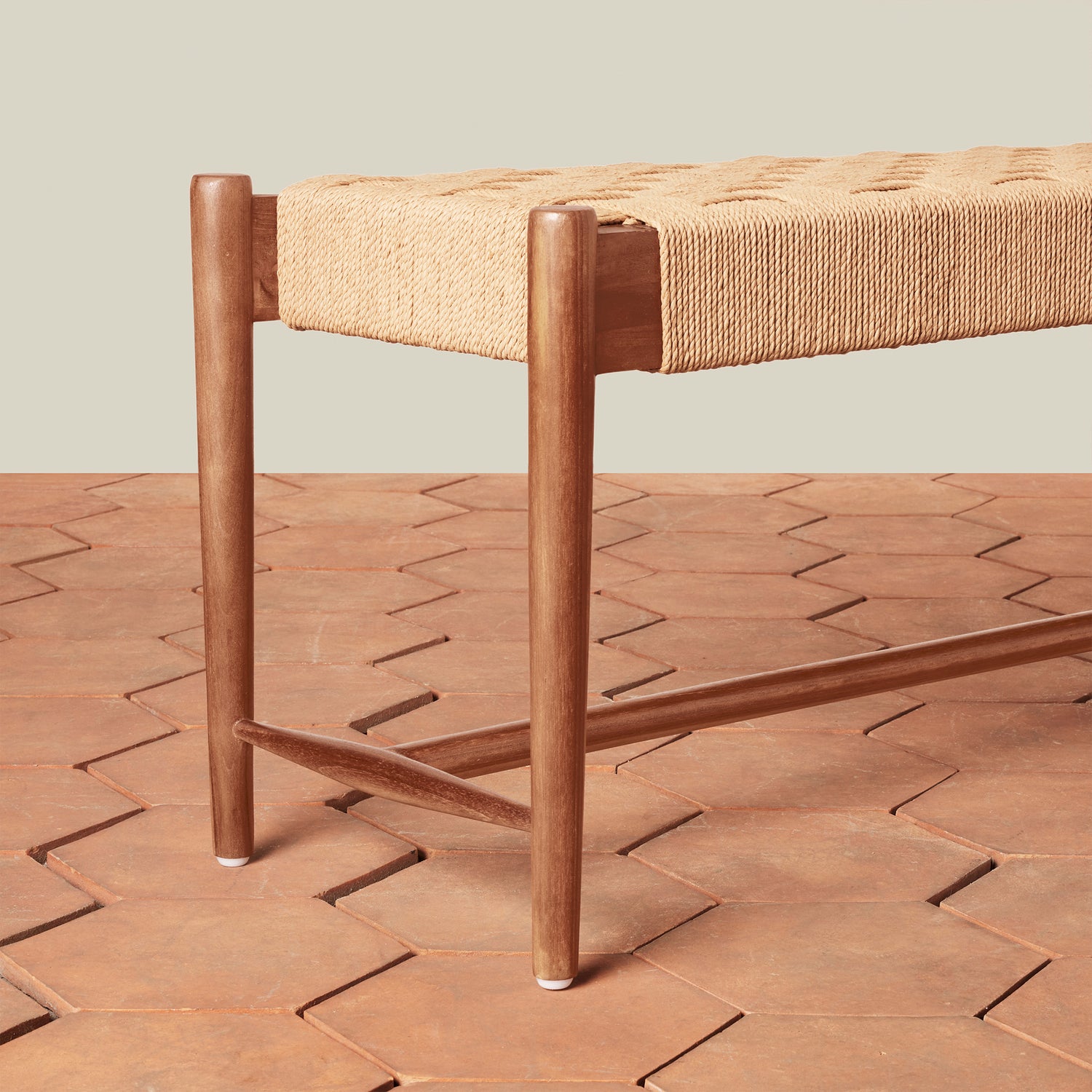 Wooden bench with woven seat on a patterned wooden floor- Number 3