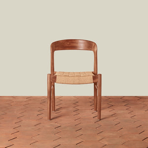 Wooden chair with woven seat on a wooden floor and beige wall background - Number 5