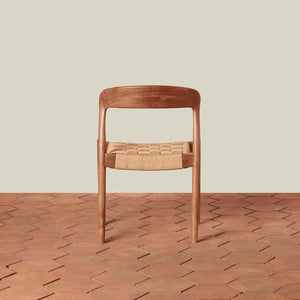 Wooden chair with woven seat on a wooden floor and beige wall background - Number 6