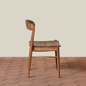 Wooden chair on a textured floor with a neutral background - Number 2