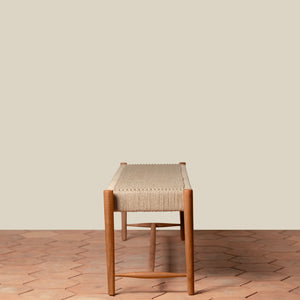 Wooden stool with woven seat on a wooden floor and beige wall background - Number 3