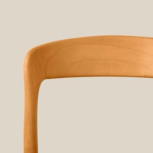 Close-up of a mustard yellow chair with a beige cushion on a beige background - Number 6