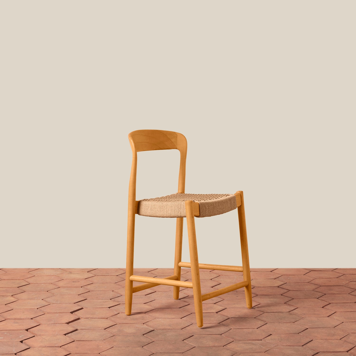 Wooden bar stool with woven seat on a wooden floor and beige wall background- Number 1